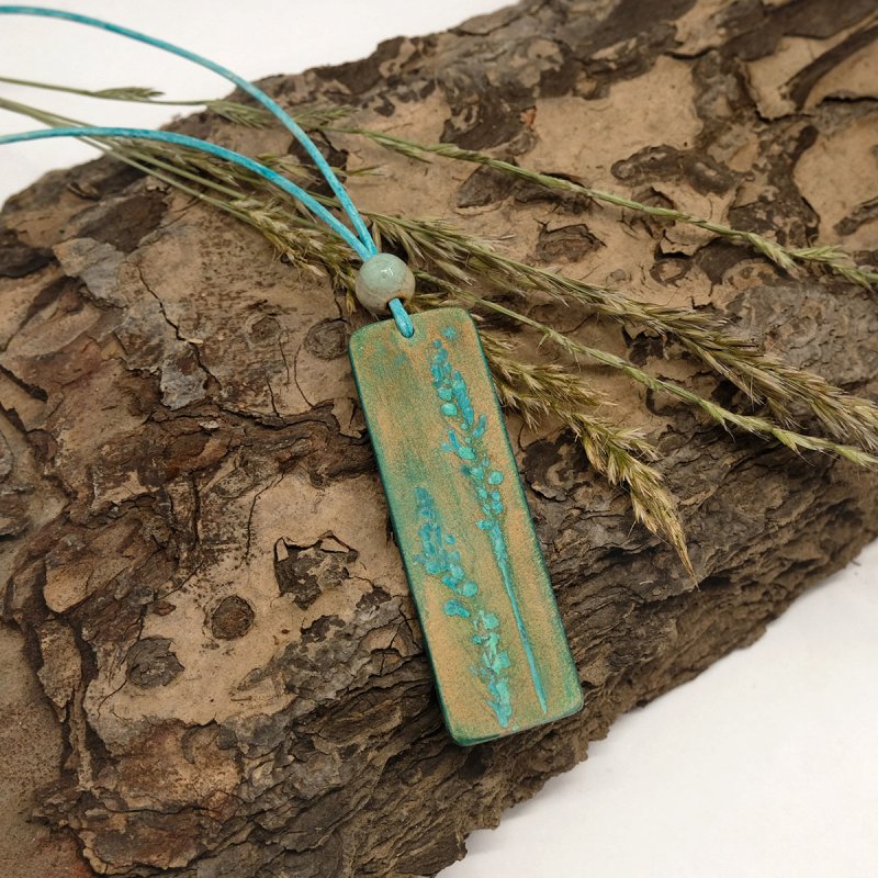 Turquoise and brown leather pendant with hand-tooled grass ears imprint