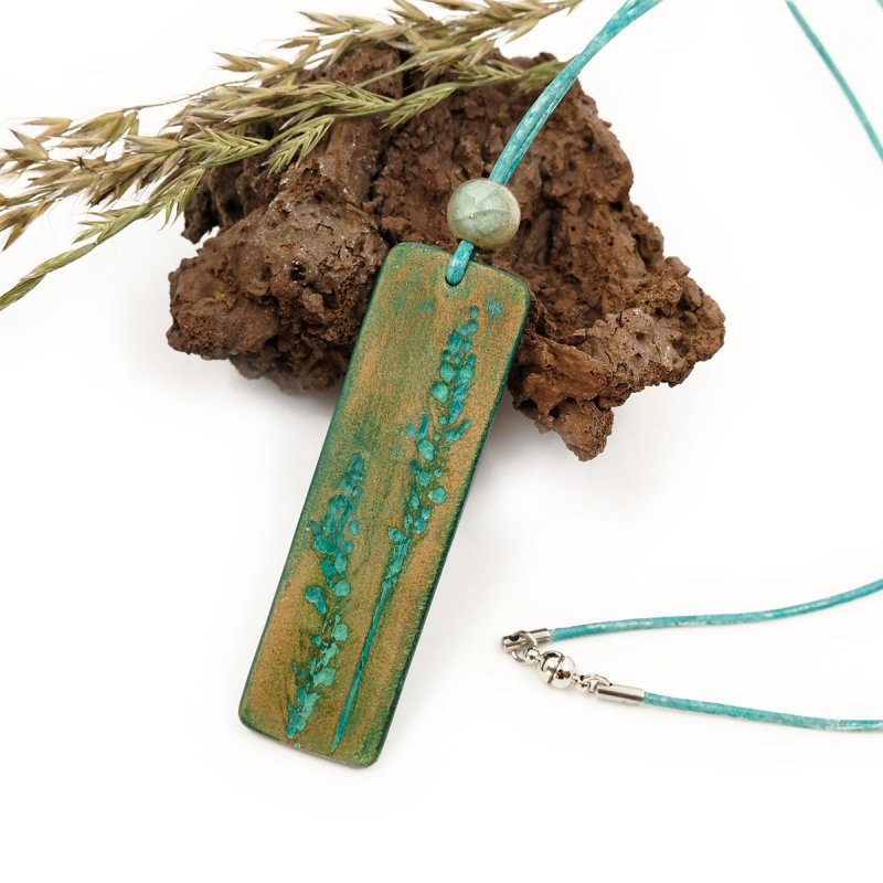 Hand-tooled leather pendant and boho style necklace