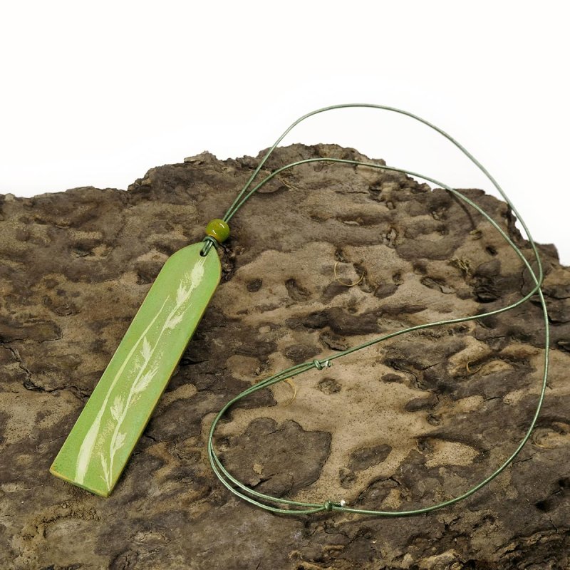 Sage green leather pendant on a